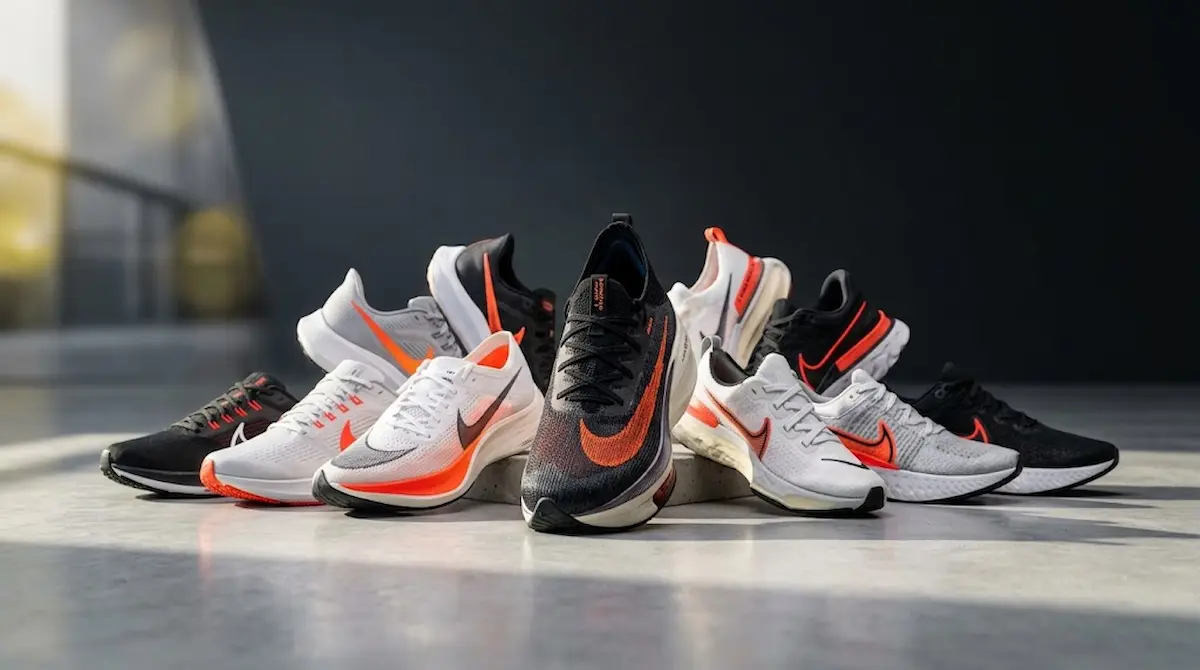 Oito tênis Nike para corrida masculino dispostos em estúdio, comparativo dos melhores modelos de 2026